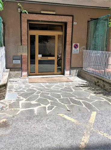 a front door of a building with a stone floor at FRONTE del GOLF in Rapallo
