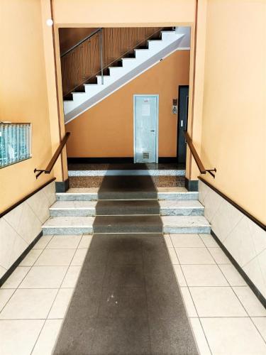 an empty hallway of a building with stairs at FRONTE del GOLF in Rapallo