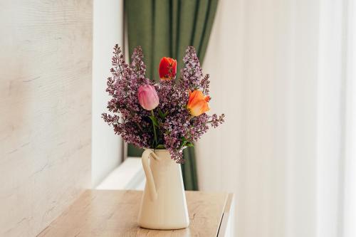 a vase filled with flowers sitting on a table at Blumenhof Bucovina in Voronet