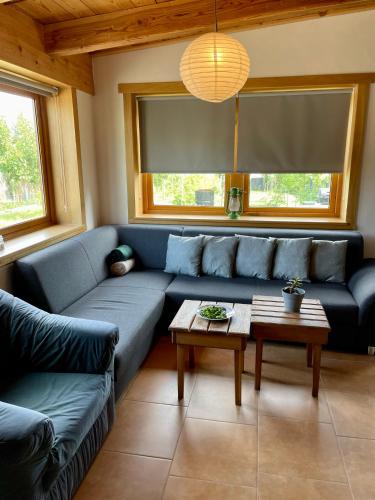 a living room with a blue couch and a table at Drozdí hnízdo in Horní Břečkov