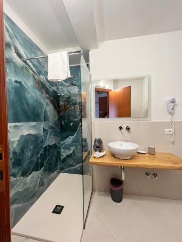 a bathroom with a sink and a shower at Labiente Suite & Breakfast in Peschici