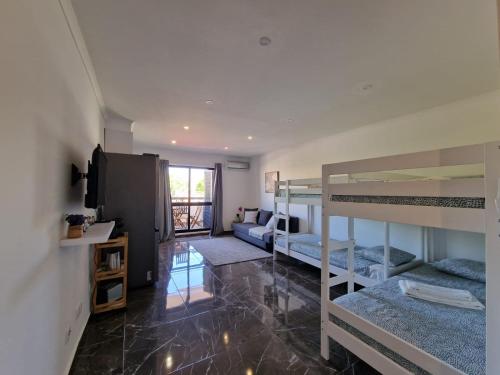 a room with bunk beds and a living room at Stunning Apartment Near Clubs in Albufeira