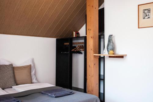 a bedroom with a bed and a wooden ceiling at Endretro Apartments in Siófok