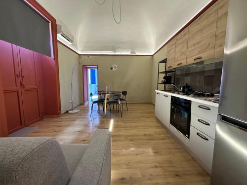 a kitchen with a table and a dining room at Beauty Apartment in Catania