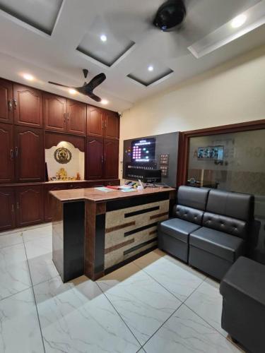 a kitchen with a bar with a couch and a table at HOTEL VIGHNESHWARA INN in Vijayawāda