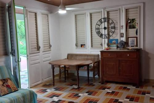 a dining room with a table and a table at Maison spacieuse agréable in Le Morne-Vert