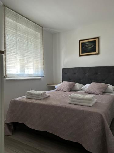a bedroom with a bed with two towels on it at Apartment Rovci 2 in Slatine