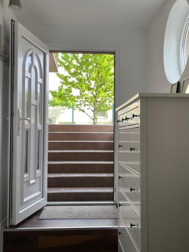 a hallway with a door and stairs with a window at Apartma FIREFLY2 in Ljubljana
