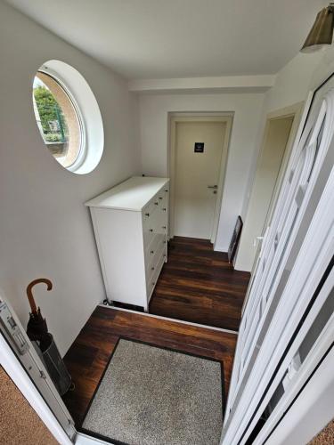 a room with a staircase with a circular window and a door at Apartma FIREFLY2 in Ljubljana