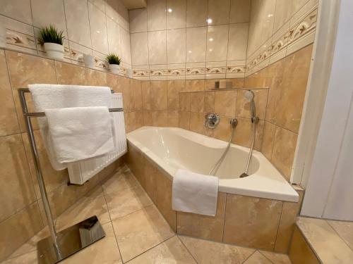 a bathroom with a bath tub and towels in it at Ferienhaus Römer in Wirft