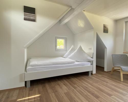 a bedroom with a bed in a attic at Ferienhaus Römer in Wirft