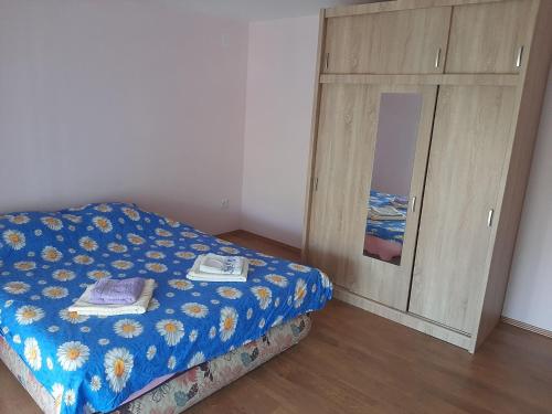 a bedroom with a bed and a wooden cabinet at Sunny in Trnava