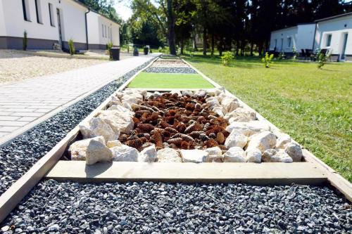 a rock garden with a pile of insects in it at Alpok – Spirit Apartman Park (Kőszegszerdahely) in Kőszeg