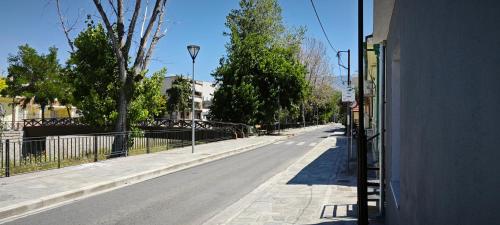 an empty street with a street light on the side of a building at River House in Volos