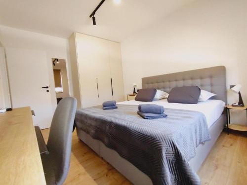 a bedroom with a bed with blue towels on it at Villa Ankica in Tribunj