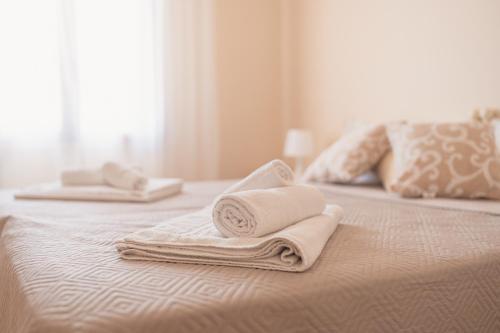 two towels are sitting on top of a bed at Ancóramare view in Stintino