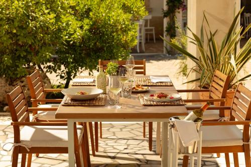 a wooden table and chairs on a patio at Hotel Resort Mulino a Vento in Uggiano la Chiesa