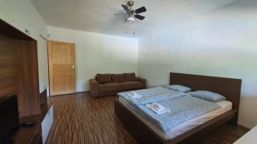 a bedroom with a bed and a couch at 4 room flat with garden and pool in Kittsee