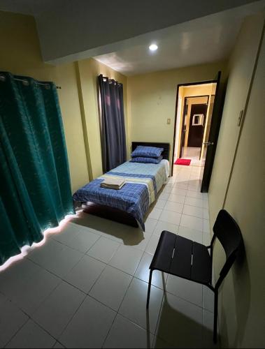 a bedroom with a bed and a chair in it at House to rent in a Gated Community with 24hr Security in Lawa-an