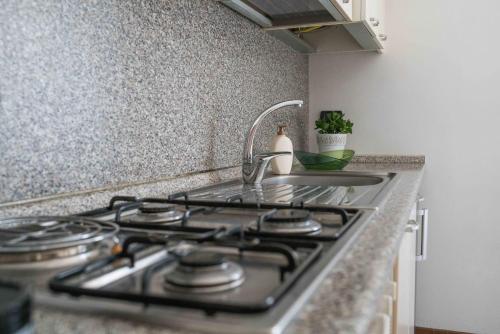a kitchen counter with a stove and a sink at "Le Charmant" - CIR VDA-SAINT-VINCENT-n 0004 in Saint Vincent