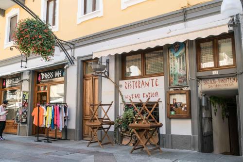 a store on a street with clothes in the windows at "Le Charmant" - CIR VDA-SAINT-VINCENT-n 0004 in Saint Vincent