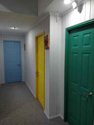 a hallway with two doors and a yellow and blue door at Hostal 1009 Valdivia in Valdivia