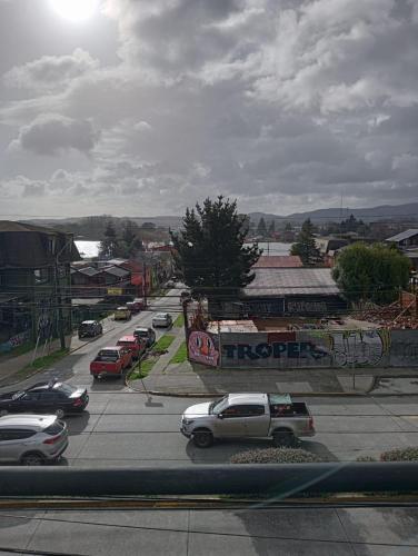 a street with cars parked in a parking lot at Hostal 1009 Valdivia in Valdivia