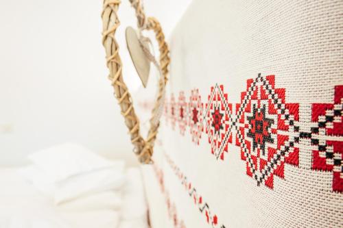 a close up of a red and white embroidery on a wall at Blumenhof Bucovina in Voronet