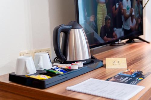 a tea kettle on a desk with a tv at Hotel Art in Sarajevo