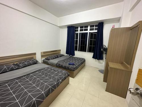 um quarto com 2 camas e uma janela em D'CAMERON MUSLIM HOMESTAY em Brinchang
