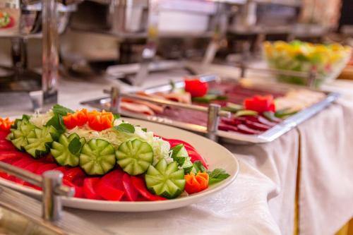 a plate of vegetables on a table in a kitchen at Hotel Art in Sarajevo