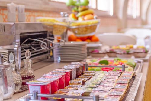 a buffet line of food on a counter in a kitchen at Hotel Art in Sarajevo