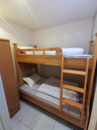 two bunk beds in a room with a ladder at Cloud9 Premium Hostel in Dubai