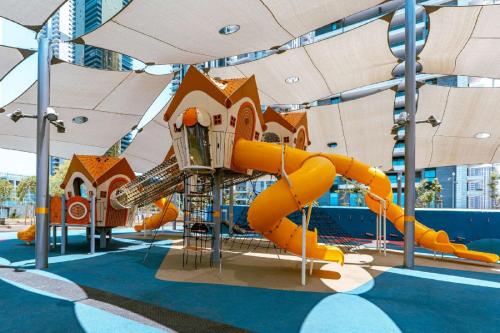 a playground in a building with a slide at Spat Vip Apartment in Bat Yam