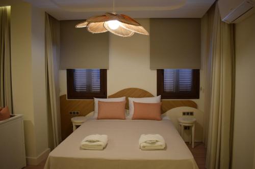 a bedroom with a bed with two towels on it at IMMYS in Seferihisar