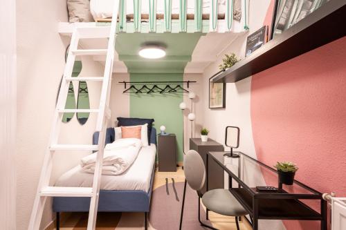 a small room with a bunk bed and a desk at Short Trips Apartment in Budapest
