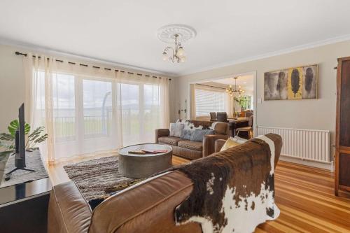 a living room with a couch and a table at Lakefront Getaway in Rotorua in Rotorua