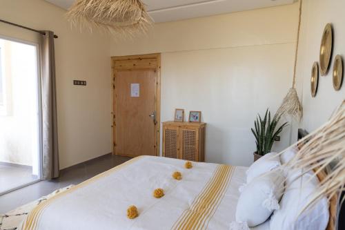 a bedroom with a large bed with two nests on it at Wavy Days in Tamraght Ouzdar