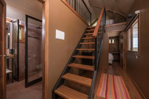a wooden staircase in a tiny house at Las Qolqas EcoResort Ollantaytambo in Ollantaytambo
