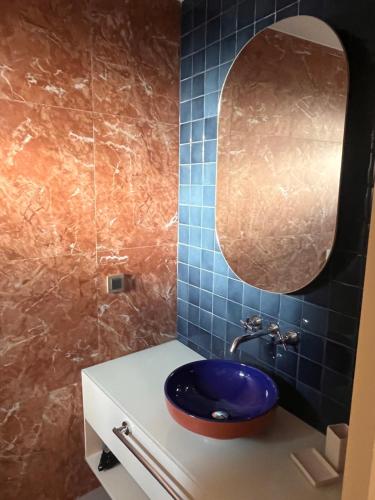 a bathroom with a sink and a mirror at IMMYS in Seferihisar