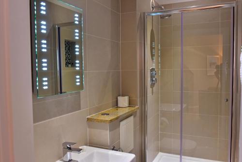 a bathroom with a shower and a sink at The Townhouse Aberfeldy - Rooms & Breakfast in Aberfeldy