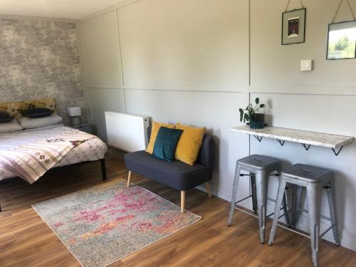 a bedroom with a bed and a chair and a table at Willow Lodge 1 in North Newton
