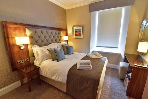 a hotel room with a bed and a window at The Townhouse Aberfeldy - Rooms & Breakfast in Aberfeldy