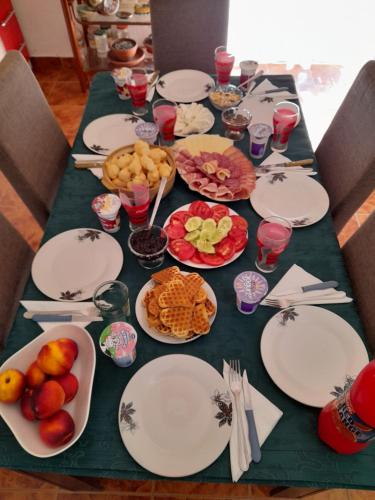 a table with plates and bowls of food on it at Farm house Godinje in Godinje