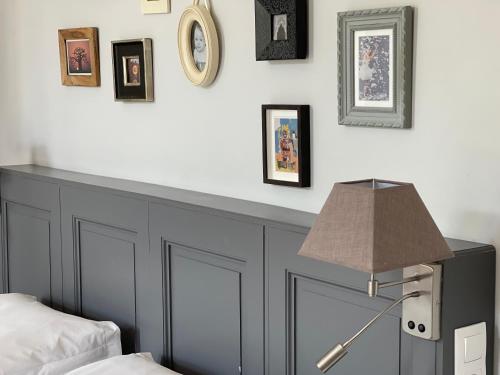 a bedroom with a bed and a desk with a lamp at Maison Dormoy in Marseille
