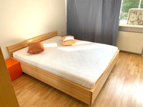 een bed met twee kussens in een slaapkamer bij Central, peaceful, pleasant in Helsinki