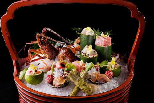 a basket of food with seafood and vegetables in it at Fufu Atami in Atami