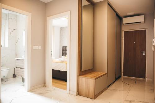 a bathroom with a door leading to a bedroom at Family apartment Mirjam in Orebić