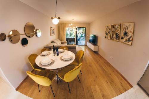 a dining room and living room with a table and chairs at Family apartment Mirjam in Orebić