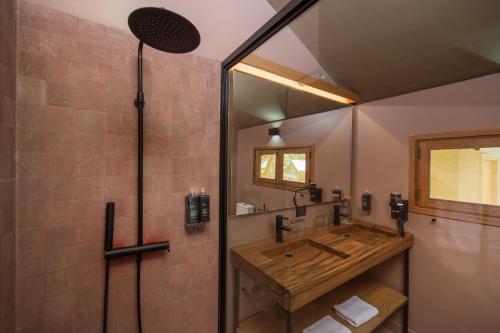 a bathroom with a sink and a shower at Las Qolqas EcoResort Ollantaytambo in Ollantaytambo